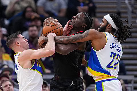 Houston Rockets center Clint Capela, center, fights for the ball with Indiana Pacers guard T.J. McConnell (9) and forward Isaiah Jackson (22) during the first half of an NBA basketball game in Indianapolis.