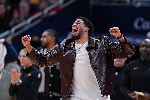 Injured Indiana Pacers guard Tyrese Haliburton (0) celebrates after a basket during the second half of an NBA basketball game between the Indiana Pacers and the Houston Rockets in Indianapolis.