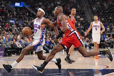 Los Angeles Clippers guard Kris Dunn (8) pressures Philadelphia 76ers guard Vj Edgecombe (77) during the first half of an NBA basketball game in Inglewood, California.