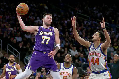 Los Angeles Lakers guard Luka Doncic (77) looks to pass the ball over New York Knicks guard Landry Shamet (44) during the second half of an NBA basketball game in New York.