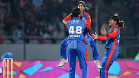 Photo: BCCI via PTI  : Delhi Capitals' Chinelle Henry celebrates with teammates Jemimah Rodrigues and Sneh Rana after taking the wicket of Royal Challengers Bengaluru's Nadine de Klerk during their Women's Premier League match in Vadodara.