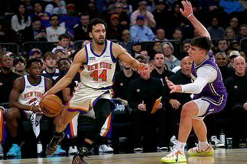 New York Knicks guard Landry Shamet (44) dribbles around Los Angeles Lakers forward Jake LaRavia, right, during the first half of an NBA basketball game in New York.