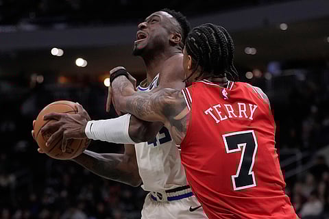 Chicago Bulls' Dalen Terry fouls Milwaukee Bucks' Thanasis Antetokounmpo during the second half of an NBA basketball game in Milwaukee.