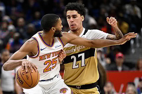 New York Knicks guard Mikal Bridges (25) dribbles against Washington Wizards guard Will Riley during the first half of an NBA basketball game in Washington. 