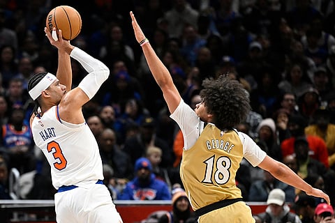 New York Knicks guard Josh Hart (3) goes to shoot against Washington Wizards forward Kyshawn George (18) during the first half of an NBA basketball game in Washington.