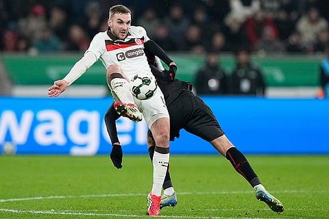 St. Pauli's James Sands passes the ball during a DFB Pokal, German Cup quarter final soccer match between Leverkusen and St. Pauli in Leverkusen, Germany.