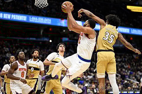 New York Knicks center Karl-Anthony Towns goes to shoot against Washington Wizards forward Marvin Bagley III (35) during the second half of an NBA basketball game in Washington.