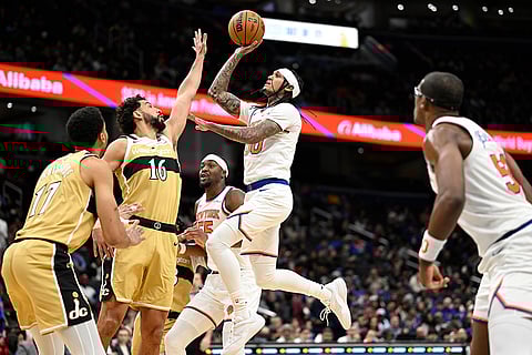 New York Knicks guard Jordan Clarkson goes to shoot against Washington Wizards forward Anthony Gill (16) during the second half of an NBA basketball game in Washington.