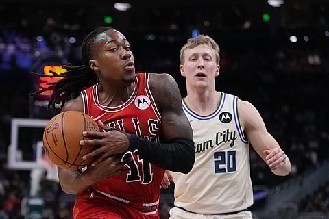 Chicago Bulls' Ayo Dosunmu loses the ball in front of Milwaukee Bucks' AJ Green during the first half of an NBA basketball game in Milwaukee.