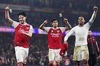 Photo: John Walton/PA via AP : Arsenal players, from left, Declan Rice, Piero Hincapie and Gabriel celebrate after the English League Cup semifinal second leg soccer match between Arsenal and Chelsea in London.