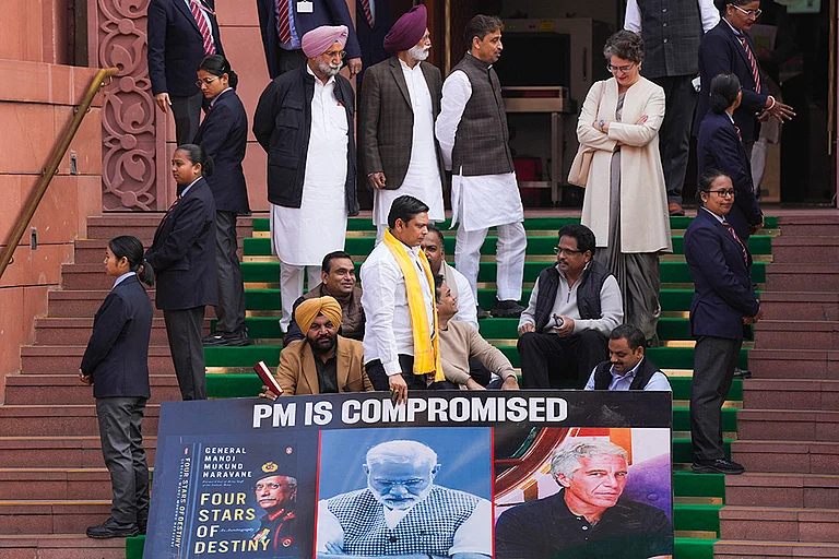 Congress MP Priyanka Gandhi Vadra with Lok Sabha MPs who were suspended on Tuesday for the remainder of the Budget session for "unruly behaviour'', as they stage a protest with a poster ‘'PM is compromised'’, at Parliament premises in New Delhi. - | Photo: PTI/Salman Ali