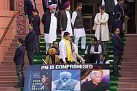 | Photo: PTI/Salman Ali : Congress MP Priyanka Gandhi Vadra with Lok Sabha MPs who were suspended on Tuesday for the remainder of the Budget session for "unruly behaviour'', as they stage a protest with a poster ‘'PM is compromised'’, at Parliament premises in New Delhi.
