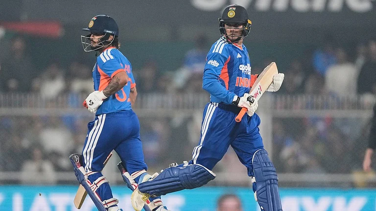 Ishan Kishan, left, and Abhishek Sharma run between the wickets during the third T20I between India and New Zealand in Guwahati. - Photo: AP