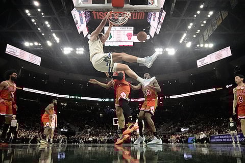 Milwaukee Bucks' Jericho Sims dunks during the second half of an NBA basketball game against the Chicago Bulls in Milwaukee. 