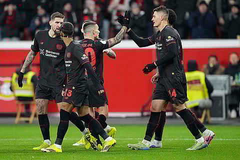 Leverkusen's Patrik Schick, right, reacts after scoring during a DFB Pokal, German Cup quarter final soccer match between Leverkusen and St. Pauli in Leverkusen, Germany.