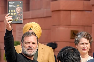| Photo: PTI/Shahbaz Khan : Leader of Opposition in the Lok Sabha Rahul Gandhi shows a copy of the unpublished "memoir" of former Army chief M M Naravane during the Budget Session of Parliament, in New Delhi. Congress MP Priyanka Gandhi Vadra also seen.