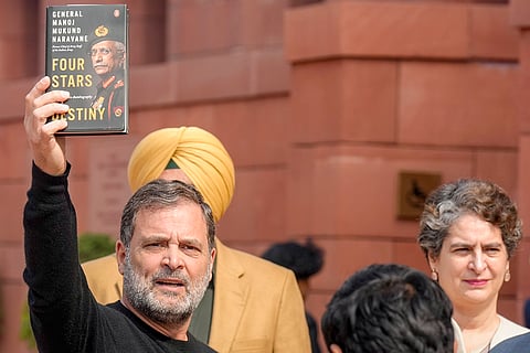 Leader of Opposition in the Lok Sabha Rahul Gandhi shows a copy of the unpublished "memoir" of former Army chief M M Naravane during the Budget Session of Parliament, in New Delhi. Congress MP Priyanka Gandhi Vadra also seen. 