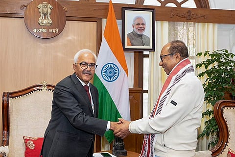 Manipur Governor Ajay Bhalla, left, meets BJP Manipur leader Yumnam Khemchand Singh, who submitted the claim to form a BJP-led NDA government, at the Raj Bhavan, in Imphal. 