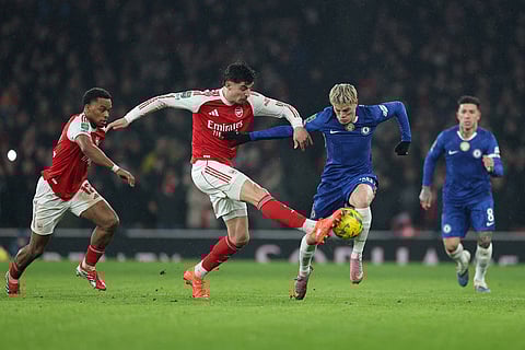 Arsenal's Kai Havertz, center left, and Chelsea's Alejandro Garnacho challenge for the ball during the English League Cup semifinal second leg soccer match between Arsenal and Chelsea in London.