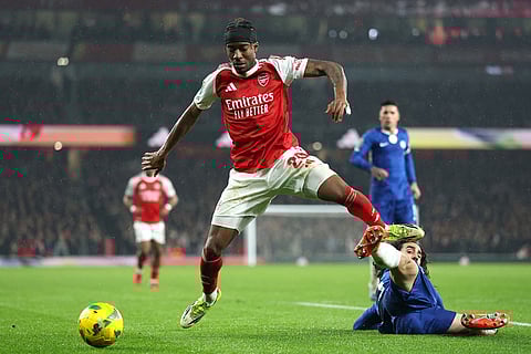 Arsenal's Noni Madueke, left, and Chelsea's Marc Cucurella challenge for the ball during the English League Cup semifinal second leg soccer match between Arsenal and Chelsea in London.