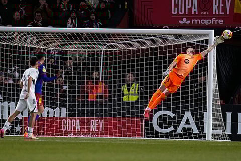 Barcelona's goalkeeper Joan Garcia jumps for the ball during a Copa del Rey quarterfinal soccer match between Albacete and Barcelona, in Albacete, Spain.