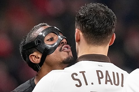 Leverkusen's Arthur, left, and St. Pauli's Danel Sinani argue during a DFB Pokal, German Cup quarter final soccer match between Leverkusen and St. Pauli in Leverkusen, Germany.