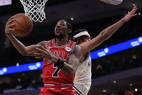 Chicago Bulls' Dalen Terry shoots past Milwaukee Bucks' Jericho Sims during the first half of an NBA basketball game in Milwaukee. 