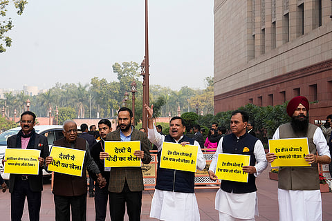 AAP MPs Sanjay Singh, Malwinder Singh Kang, Raj Kumar Chabbewal and other party leaders stage a protest over the India-US Trade Agreement during the Budget Session of Parliament, in New Delhi.