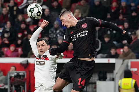 St. Pauli's Manolis Saliakas, left, and Leverkusen's Patrik Schick fight for the ball during a DFB Pokal, German Cup quarter final soccer match between Leverkusen and St. Pauli in Leverkusen, Germany.