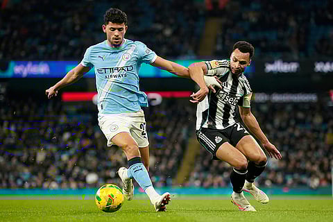 Manchester City's Matheus Nunes, left, ansd Newcastle's Jacob Murphy fight for the ballduring the English League Cup semifinal soccer match soccer match between Manchester City and Newcastle in Manchester, England.