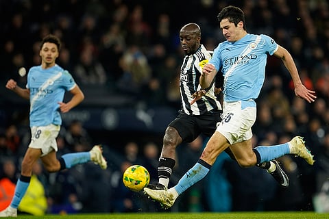 Yoane Wissa, left, and Manchester City's Abdukodir Khusanov fight for the ball during the English League Cup semifinal soccer match soccer match between Manchester City and Newcastle in Manchester, England.
