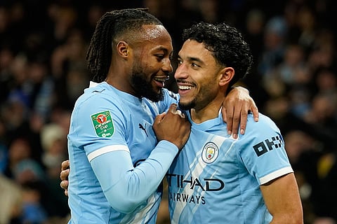 Manchester City's Antoine Semenyo, left, and Omar Marmoush celebrate after scoring during the English League Cup semifinal soccer match soccer match between Manchester City and Newcastle in Manchester, England.