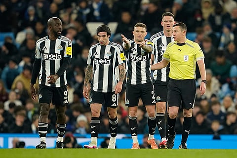Newcastle players argue with a referee during the English League Cup semifinal soccer match soccer match between Manchester City and Newcastle in Manchester, England.
