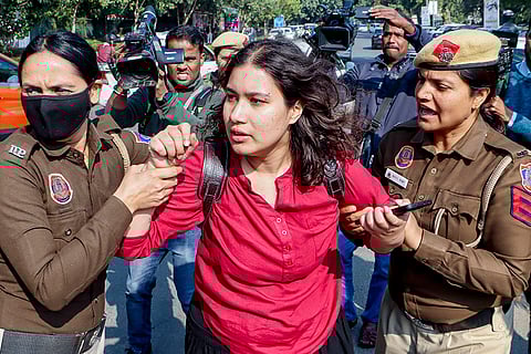 Police personnel detain a Students' Federation of India (SFI) member during a demonstration against the 2026 UGC regulations on preventing caste-based discrimination on campuses, at Ministry of Education, in New Delhi.