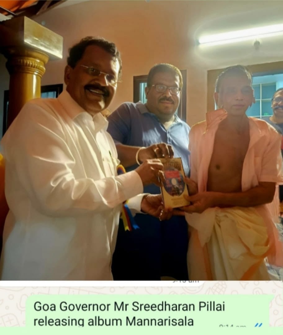 Men presenting an album during an indoor cultural event.