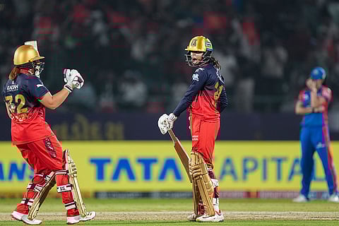 Royal Challengers Bengaluru's Radha Yadav and Nadine de Klerk celebrate after the team won the Women's Premier League (WPL) 2026 final T20 cricket match against Delhi Capitals, at Baroda Cricket Association Stadium, Kotambi in Vadodara, Gujarat.