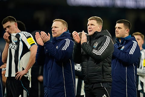 Newcastle's head coach Eddie Howe, center walks off the pitch after the English League Cup semifinal soccer match soccer match between Manchester City and Newcastle in Manchester, England.