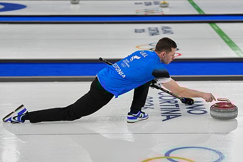 Estonia's Harri Lill in action during the mixed doubles round robin phase of the curling competition against Switzerland at the 2026 Winter Olympics, in Cortina d'Ampezzo, Italy.