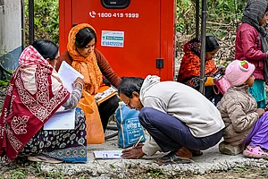 | Photo: PTI : People arrange their documents during hearings under the Special Intensive Revision (SIR) of electoral rolls, in Nadia, West Bengal.