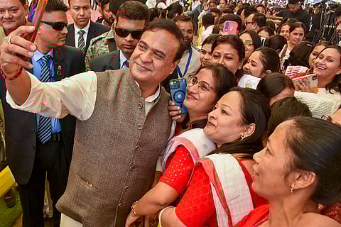 Assam Chief Minister Himanta Biswa Sarma takes selfies with beneficiaries of the 'Mukhyamantri Mahila Udyamita Abhiyan', a scheme for women Self-Help Groups, during an event, in Sivasagar district, Assam.