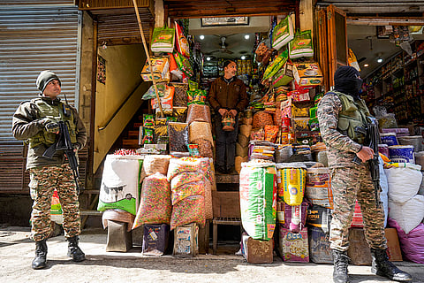 Security personnel conduct a search operation as part of security arrangements for the Home Minister's visit, in Srinagar.