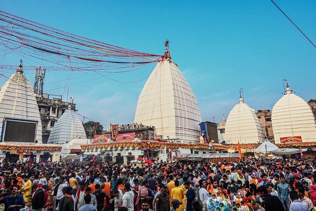 A vast crowd of devotees gathered in front of the white spires of Deoghar Temple in Jharkhand.