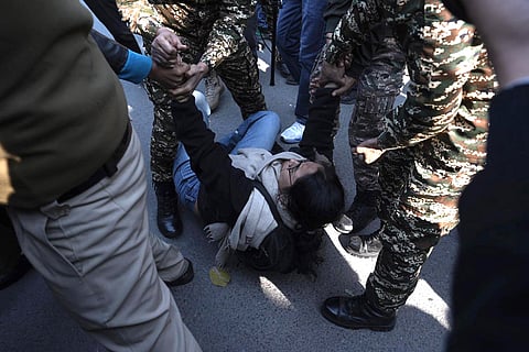 Police personnel detain a Students' Federation of India (SFI) member during a demonstration against the 2026 UGC regulations on preventing caste-based discrimination on campuses, at Ministry of Education, in New Delhi.