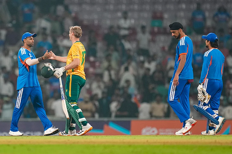 India's captain Suryakumar Yadav and South Africa's Corbin Bosch exchange greetings after the former's team won the ICC Men's T20 World Cup warm-up cricket match against South Africa, at the DY Patil Sports Academy, in Navi Mumbai. - | Photo: PTI/Shashank Parade