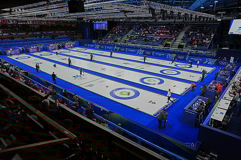 Athletes play mixed doubles curling match at the 2026 Winter Olympics, in Cortina d'Ampezzo, Italy.