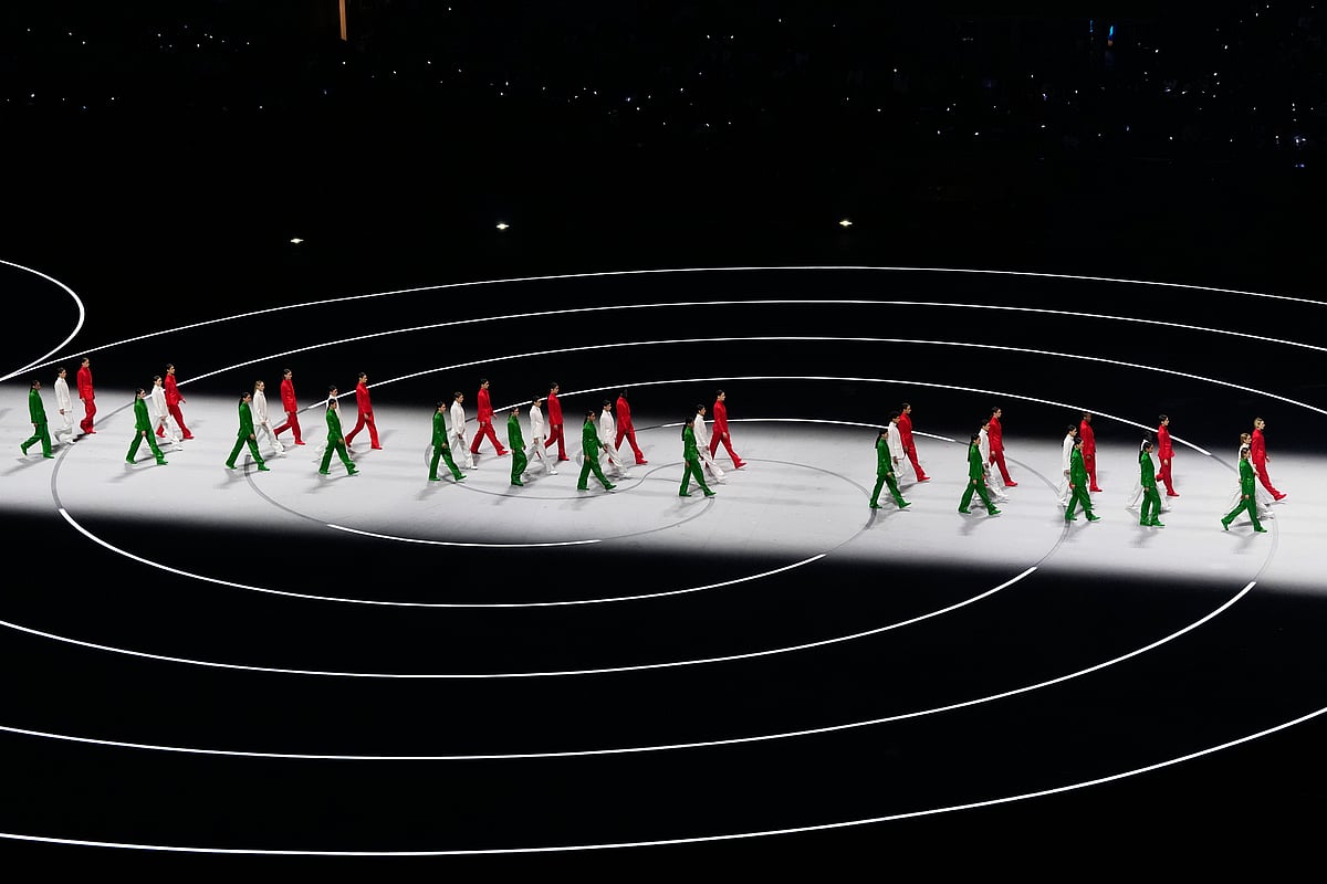 Artists wearing Italian colors perform during the Olympic opening ceremony at the 2026 Winter Olympics, in Milan, Italy, Friday, Feb. 6, 2026.