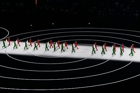 Artists wearing Italian colors perform during the Olympic opening ceremony at the 2026 Winter Olympics, in Milan, Italy, Friday, Feb. 6, 2026.
