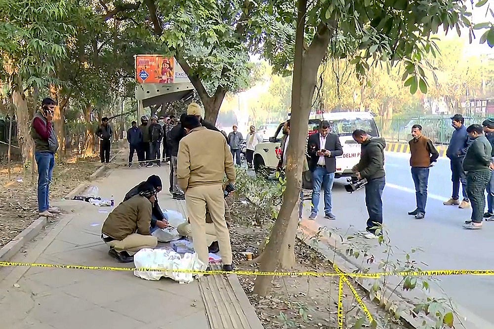 Police personnel investigate the spot after two wanted persons were arrested following a brief encounter, at RK Puram area, in New Delhi. - | Photo: PTI