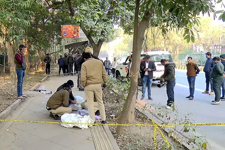 Police personnel investigate the spot after two wanted persons were arrested following a brief encounter, at RK Puram area, in New Delhi. - | Photo: PTI