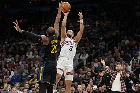 Phoenix Suns forward Dillon Brooks (3) shoots over Golden State Warriors center Al Horford during the first half of an NBA basketball game in Phoenix.